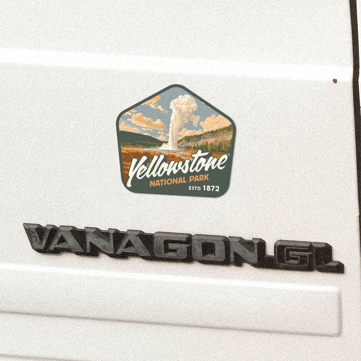 Waterproof vinyl sticker of Yellowstone National Park Geyser on the back of a white Volkswagen Vanagon GL. Features captivating mountain art, perfect hiking sticker for outdoor enthusiasts.